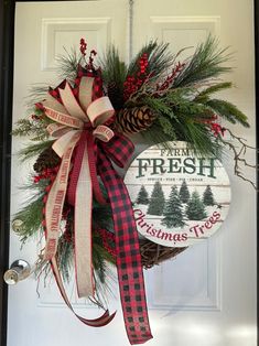 a christmas wreath hanging on the front door