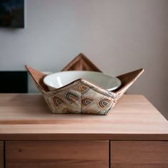 a bowl sitting on top of a wooden table