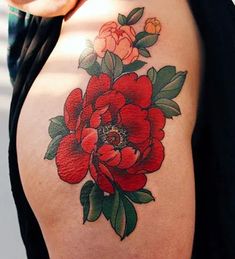 a close up of a woman's thigh with red flowers on the side and green leaves