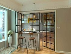 a kitchen with two stools and an island in front of a window that opens to the outside