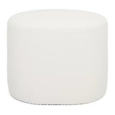 a white round ottoman sitting on top of a white floor