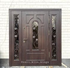 the front door is made of wood and has intricate iron work on it's sides