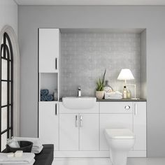 a white bathroom with grey walls and tile flooring, along with a toilet and sink