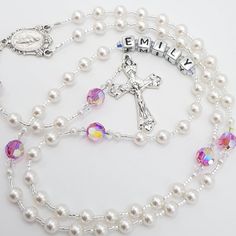 Elegant and dainty Rosary beads made with white Swarovski pearls for Hail Mary and complimented by beautiful pink iridescent crystal Swarovski beads for Our Father. Beautiful gift for many occasions such as a christening for baby girl, first holy communion, baptism, confirmation, wedding rosary and much more! Add a name and/or Saint pendant to personalise and choose your own centrepiece with a wide variety available. Please select whether you would like to a add name on the rosary from drop down Pearl White Rosary For First Communion, White Rosary With Round Beads For Confirmation, White Pearl Rosary For Baptism, Personalized Rosary With Round Beads For Wedding, White 8mm Beads Wedding Rosary, Pearl Rosary With 8mm Beads For Wedding, Personalized Wedding Rosary With Round Beads, White Wedding Rosary With 8mm Beads, Personalized White Rosary For Confirmation