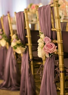 the chairs are lined up with purple drapes and pink flowers on each one side