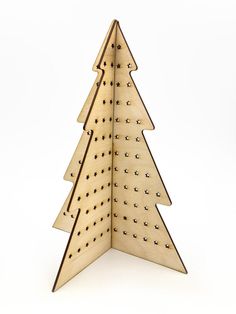 a wooden christmas tree with holes in it