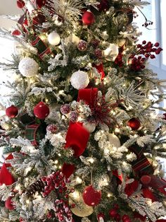 a decorated christmas tree with red and white ornaments