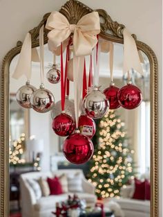 a mirror with christmas ornaments hanging from it