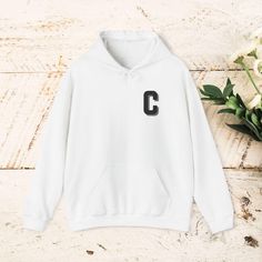 Stay cozy and stylish with our Letter C Print Unisex Heavy Blend™ Hooded Sweatshirt. This minimalist design is perfect for the autumn and winter seasons, offering a clean and modern look. A thoughtful gift for anyone who loves simplicity and comfort, this pullover jacket is a wardrobe staple that combines warmth with understated elegance. Color Accuracy: Please note that actual item colors may differ slightly. This is because computer monitors and phone screens can display colors differently, an White Hoodie With Letter Embroidery, White Winter Hoodie For College, White Fleece Hoodie With Letter Embroidery, Winter Fleece Hoodie With Letter Embroidery, Cozy Winter Hoodie With Letter Print, Winter Sweatshirt With Letter Patch Long Sleeve, Casual Hooded Hoodie With Letter Embroidery, Sporty White Hoodie With Letter Embroidery, Hooded Hoodie With Letter Embroidery For Fall