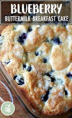 a blueberry buttermilk breakfast cake in a glass baking dish on a wooden table