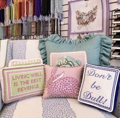 several pillows are on display in a store