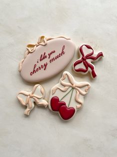 three decorated cookies on a table with words and hearts in the shape of candy canes