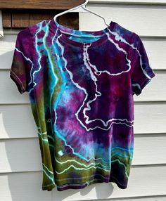 a tie dye shirt hanging on a clothes line