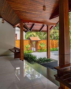 an outdoor covered area with benches and plants