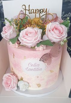 a birthday cake with pink roses and gold lettering on the top that says happy birthday cecilia