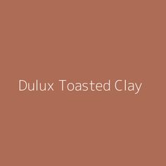 the words dulux toasted clay on a brown background