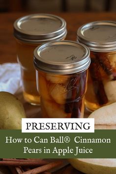 three jars filled with apples and cinnamons on top of a table next to an apple slice