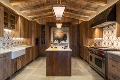 a large kitchen with wooden cabinets and white counter tops, along with an island in the middle