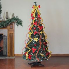 a decorated christmas tree sitting on top of a wooden floor