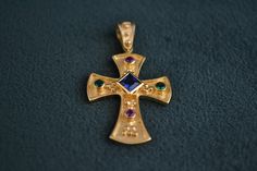 A byzantine inspired pendant that has the shape of a cross. Entirely made with solid Sterling Silver (925 Silver), with a 22K Gold-plating. The pendant is decorated with one square Cz Sapphire and four round Cz stones (2 Emerald, 2 Rubies). Handmade Byzantine Crucifix Jewelry, Handmade Byzantine Style Crucifix Jewelry, Byzantine Rings, Greek Ring, Medieval Rings, 22k Gold, Cz Stone, 925 Silver Rings, Photo Jewelry