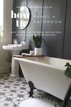 a bathtub sitting next to a white sink in a bathroom under a round mirror