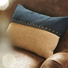 a brown couch with a blue pillow on it