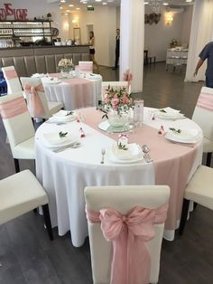 the tables are decorated with pink and white linens