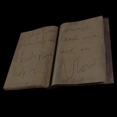 an open book with writing on it in the middle of black background, which appears to be written by someone