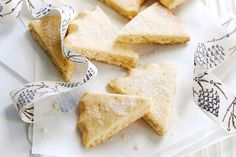 several pieces of shortbread on a plate with some napkins around it and one slice cut in half