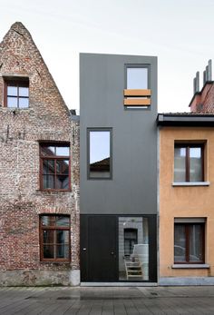 two buildings with windows on each side and one building in the middle that has stairs leading up to it