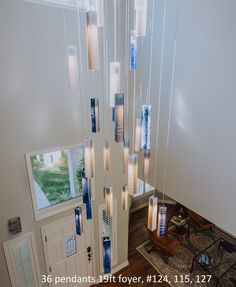 a chandelier made out of candles hanging from it's sides in a room