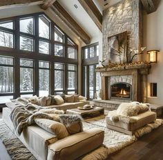 a living room filled with lots of furniture and a fire place in the middle of it