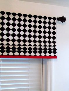 a black and white checkered valance hanging on the side of a window