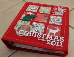 a red christmas book sitting on top of a tiled floor