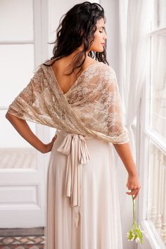 "A lace cover-up made in soft, delicate lace, perfect to match with any of our dresses for some extra coverage over the shoulders. The versatile circle design gives the shawl many possibilities, whether you want to wear it loosely over the upper arms, as a lace bolero over the shoulders or as a cape for a fuller coverage over shoulders and chest. SIZING The standard size is a onesize shawl, made to fit sizes up to EU 42/ US 12 and measures approx. 20in wide (50cm) and 57in (145cm) in circumferen Lace Winter Outfit, Ways To Wear A Shawl, Wedding Dress Cover Up, Wedding Dress Shawl, Vestido Convertible, Wedding Dress Cover, Silver Cocktail Dress, Lace Shrug, Shawl Wedding