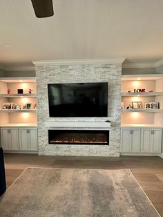 a living room with a fireplace and entertainment center