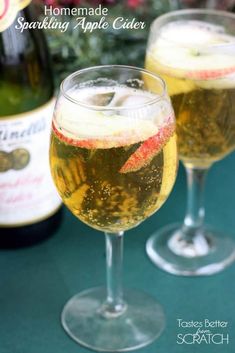 two wine glasses filled with sparkling apple cider