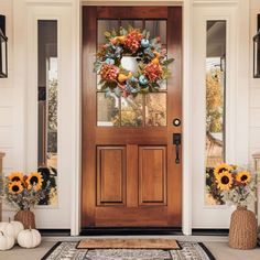 the front door is decorated with sunflowers and pumpkins