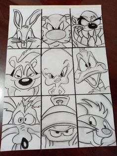 some cartoon faces drawn in pencil on paper