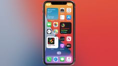 an iphone with multiple icons displayed on the screen and in front of a blurred background