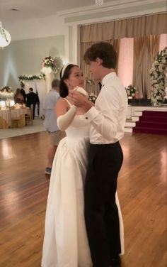 a bride and groom are dancing together on the dance floor