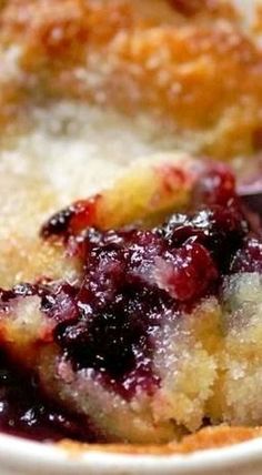 a close up of a plate of food with fruit on it and a fork in the bowl