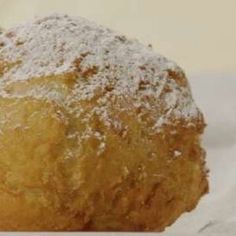 a powdered pastry sitting on top of a piece of paper