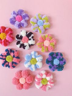 small crocheted flowers on a pink background