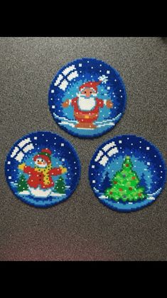 three blue plates with santa clause and christmas trees on them