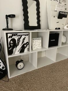 a white book shelf with various items on it