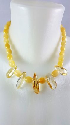 This necklace has soft yellow jade elongated tubular beads in a nice 8.5 inches in length. The 5 clear center stones are superb Citrine beads. This piece can be casual or elegant depending on your outfit. The closure is a lobster claw. Modern Hoop Earrings, Yellow Jade, Citrine Beads, Soft Yellow, Banded Agate, Choker Necklaces, Pale Yellow, Lobster Claw, Citrine