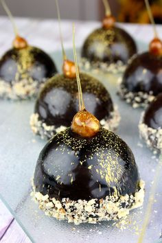 chocolate covered donuts with sprinkles and toppings on a glass plate