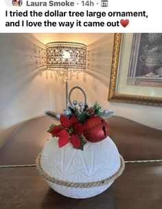 a white vase sitting on top of a table with poinsettis in it