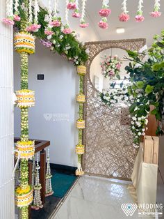 an entrance decorated with flowers and garlands